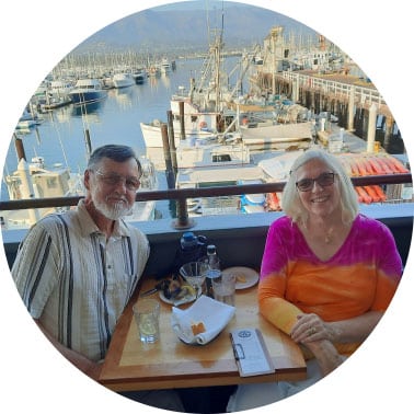 Kristin and her husband dining at a marina restaurant